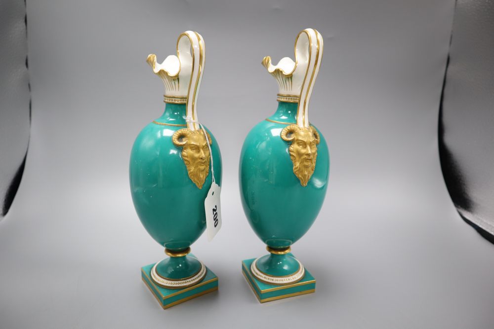 A pair of Coalport green glazed ewers, hand painted birds to the body, height 27cm